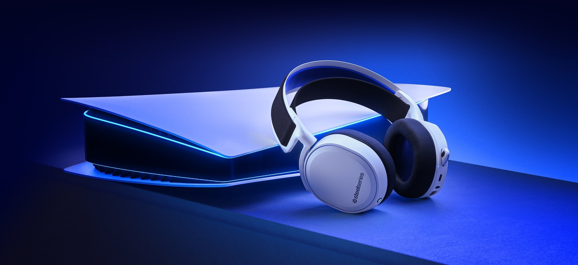 White Arctis 7P+ headset, sitting near a next generation white console.